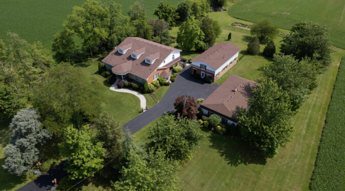 Spectacular multi-generational home with three living quarters, on a 1.86- acre lot in the countryside, and with two large outbuildings!