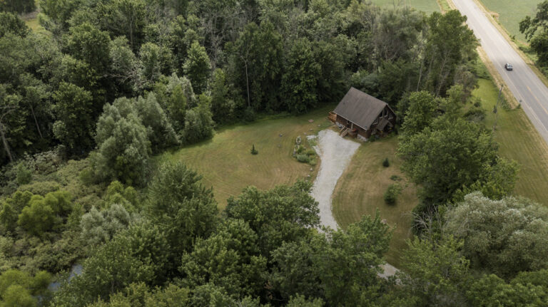 Lovely log home on a park-like 3.56 acre wooded lot in Norfolk.